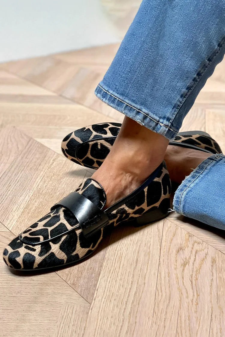 Women's black and tan animal print slip-on loafers with round toes and black straps