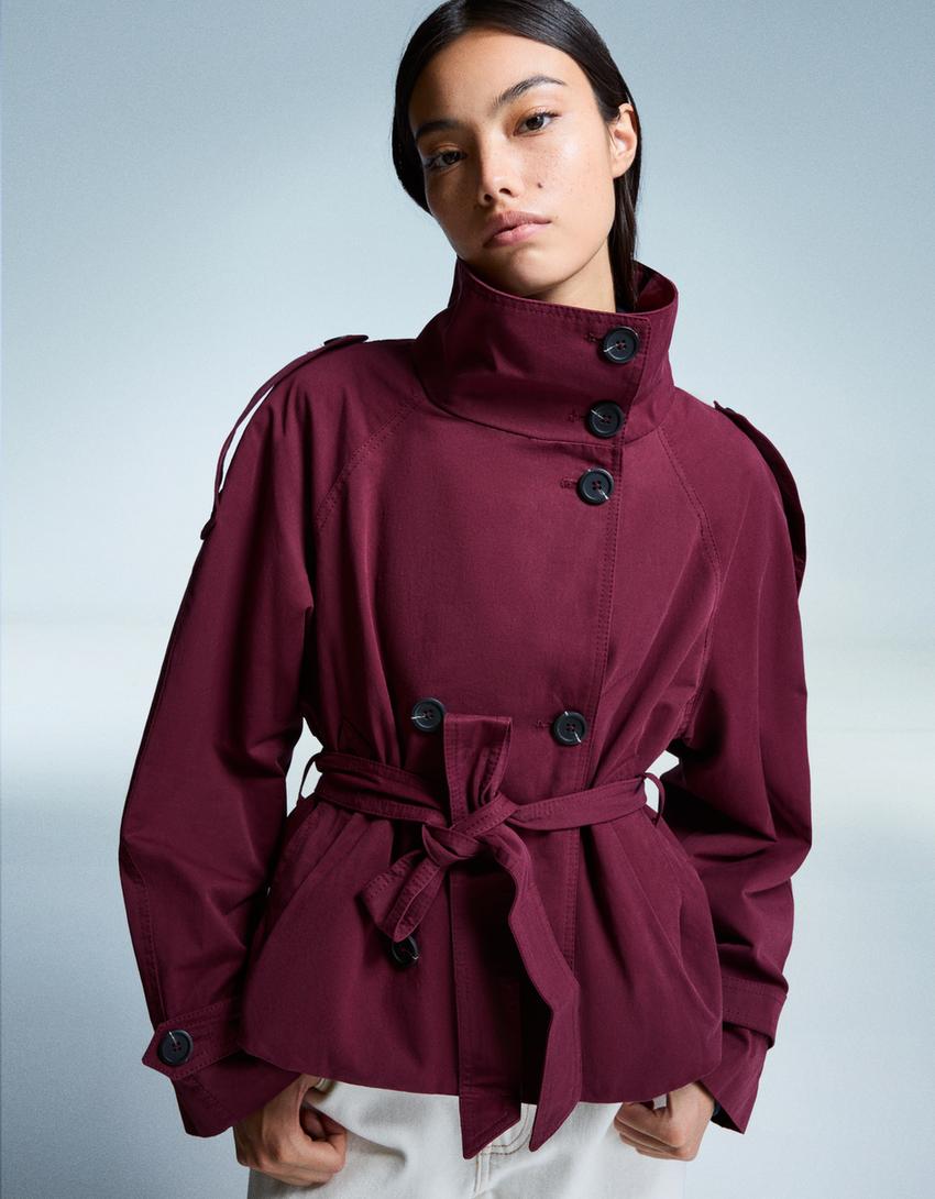 Women's short trench jacket with high collar, buttons, belt and long sleeves