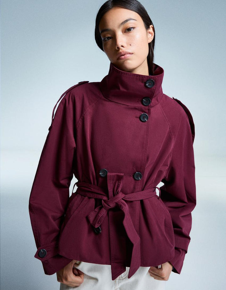 Women's short trench jacket with high collar, buttons, belt and long sleeves