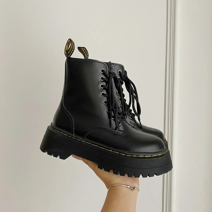 Black women's combat ankle boots with laces, side zips and platform lug soles