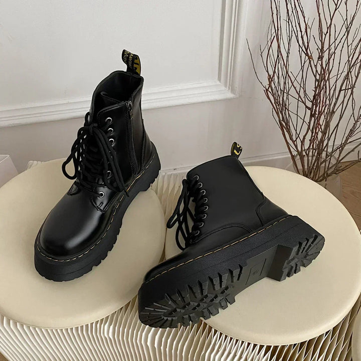 Black women's combat ankle boots with laces, side zips and platform lug soles