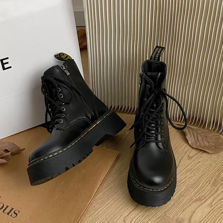 Black women's combat ankle boots with laces, side zips and platform lug soles