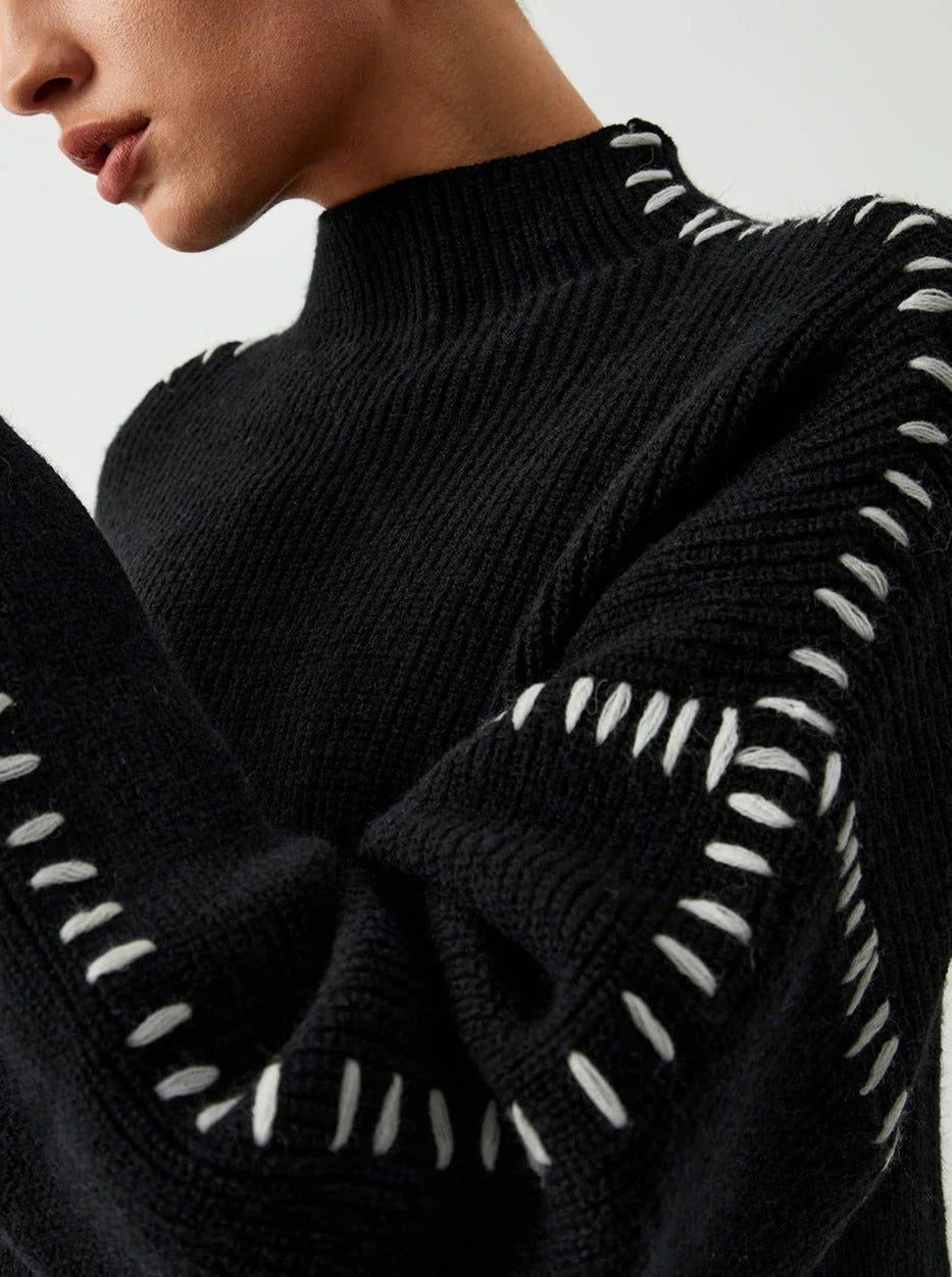 Women's ribbed knit sweater with contrast stitch trim on the sleeves and hem