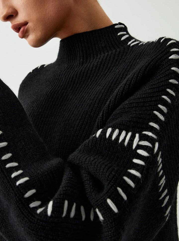 Women's ribbed knit sweater with contrast stitch trim on the sleeves and hem