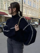 Women's ribbed knit sweater with contrast stitch trim on the sleeves and hem