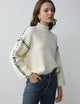 Women's ribbed knit sweater with contrast stitch trim on the sleeves and hem