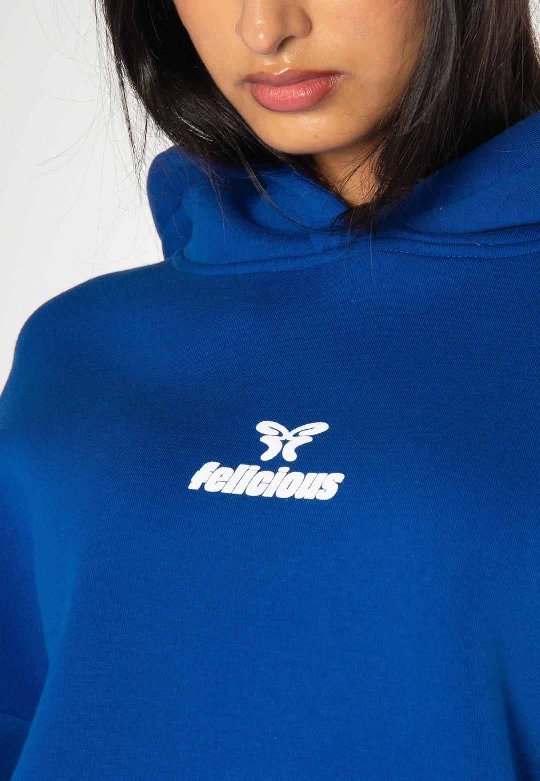 Women's blue pullover hoodie with white chest logo and hood