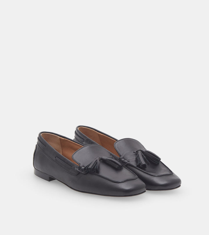Women's black slip-on loafers with tassel trim and low heel