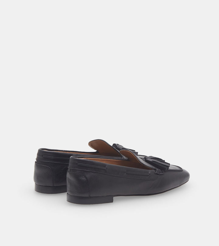Women's black slip-on loafers with tassel trim and low heel