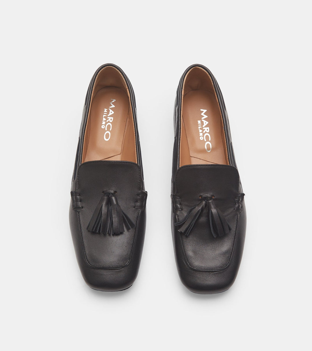 Women's black slip-on loafers with tassel trim and low heel