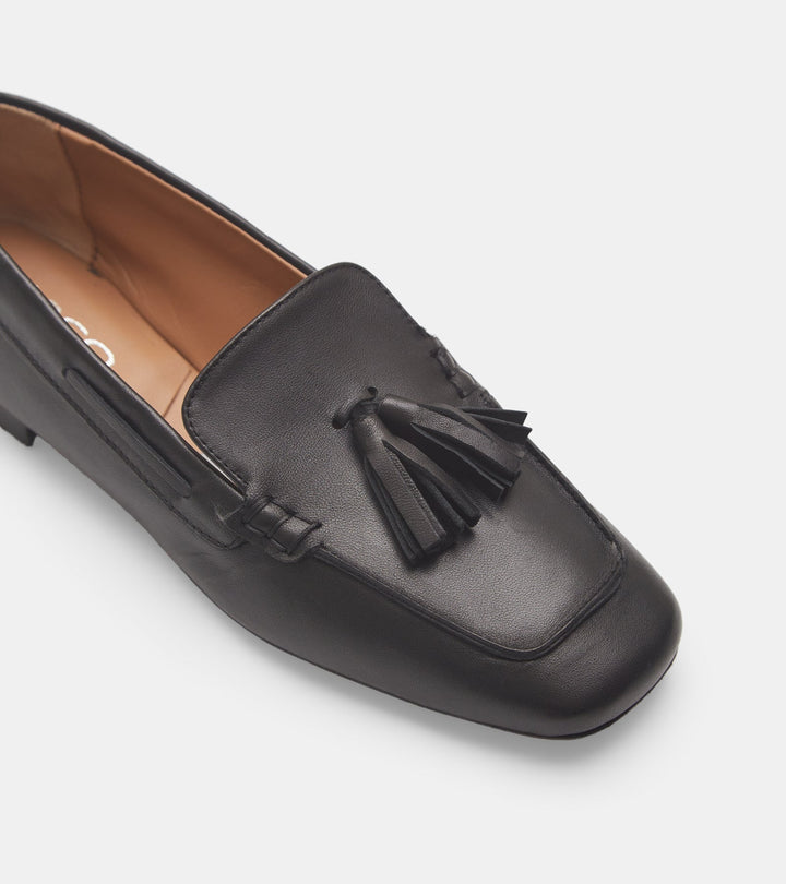 Women's black slip-on loafers with tassel trim and low heel