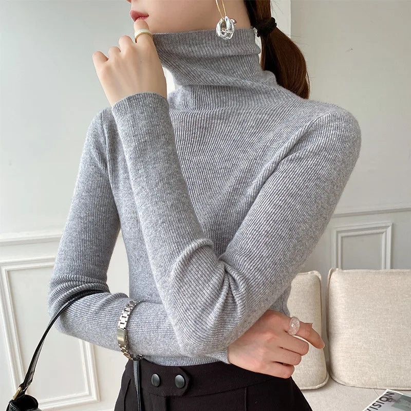 Women's ribbed turtleneck sweater with long sleeves and fitted hip-length cut