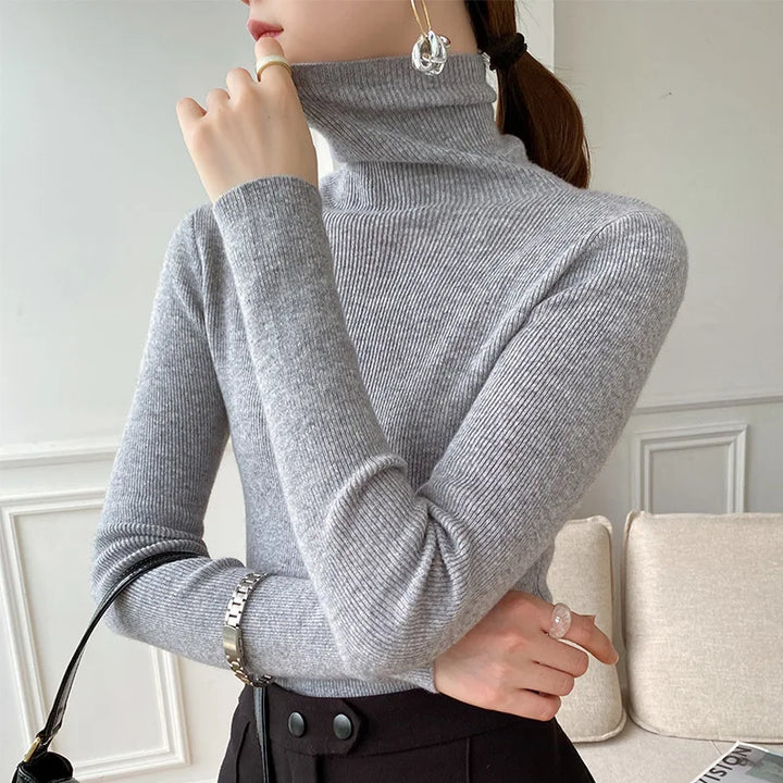 Women's ribbed turtleneck sweater with long sleeves and fitted hip-length cut