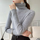 Women's ribbed turtleneck sweater with long sleeves and fitted hip-length cut