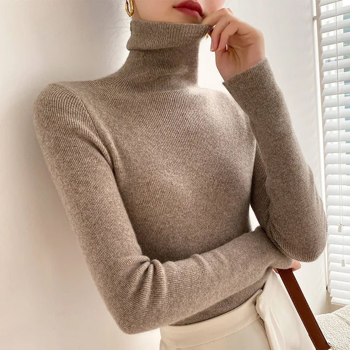 Women's ribbed turtleneck sweater with long sleeves and fitted hip-length cut