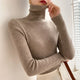 Women's ribbed turtleneck sweater with long sleeves and fitted hip-length cut