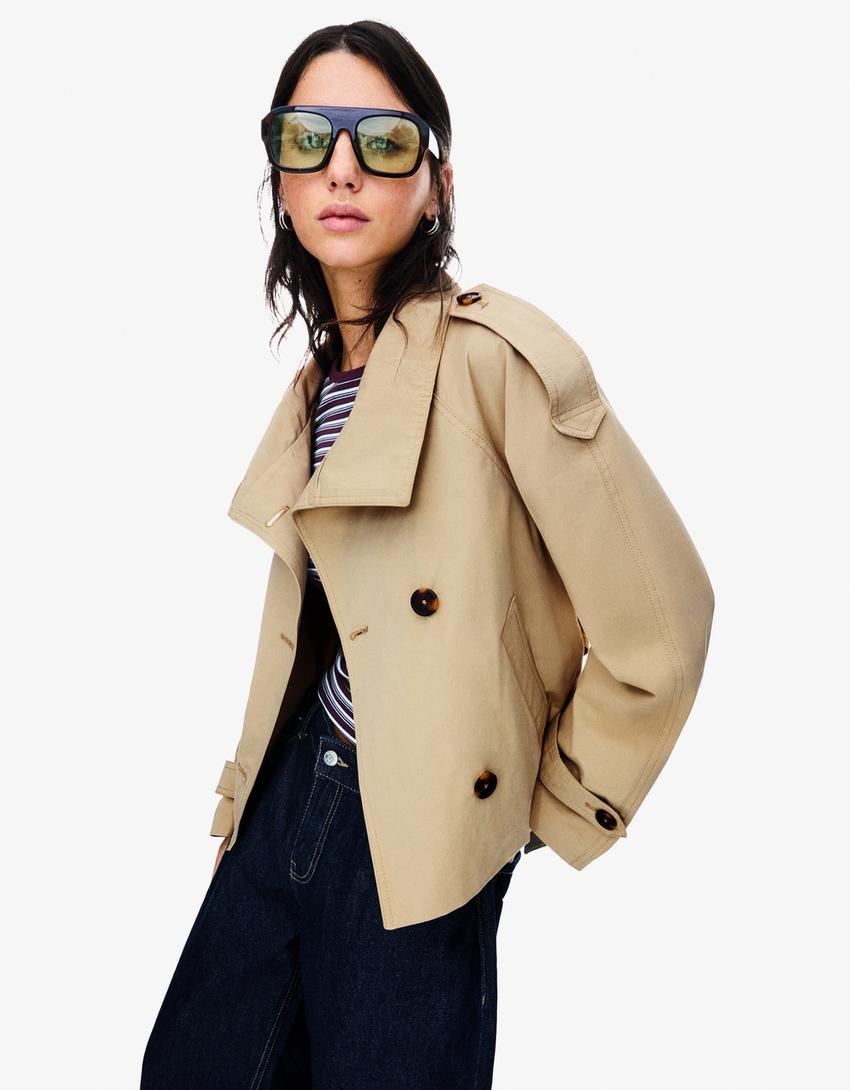 Women's short trench jacket with high collar, buttons, belt and long sleeves