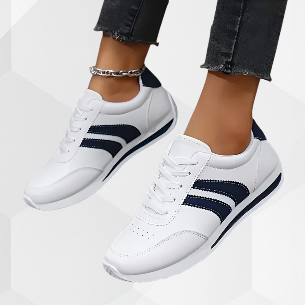 White low-top sneakers with navy side stripes and lace-up fronts