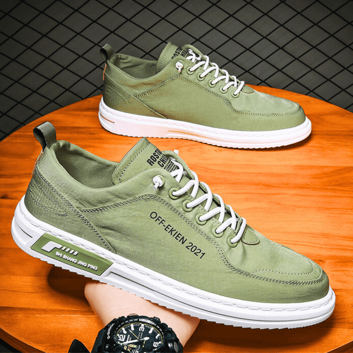 Low-top lace-up sneakers with stitched panels and contrast soles
