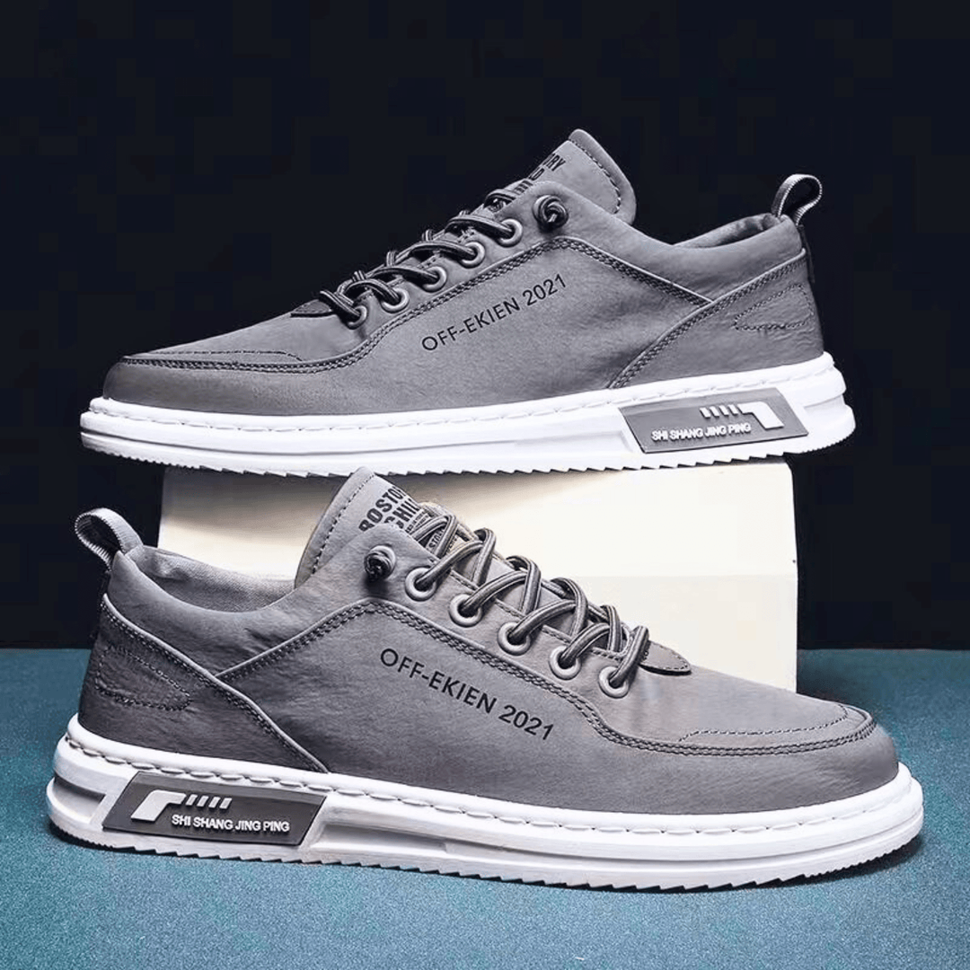 Low-top lace-up sneakers with stitched panels and contrast soles